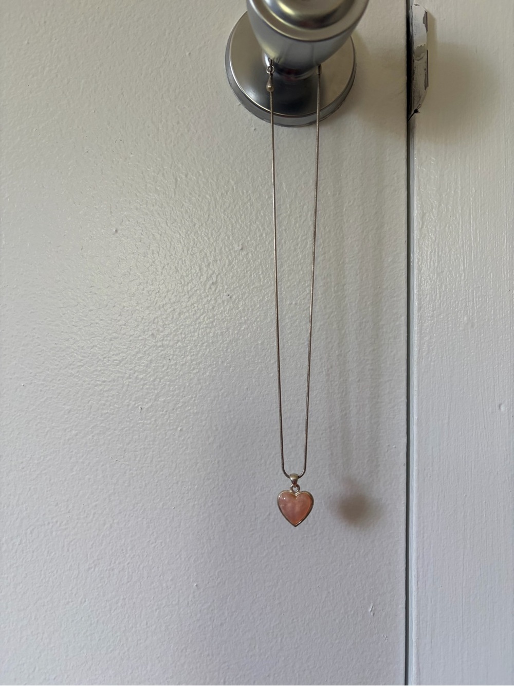 Pink heart pendant on silver tone chain